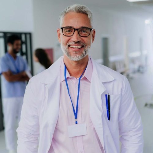 portrait-of-happy-doctor-at-hospital-corridor2-CX3VSGM-768x960